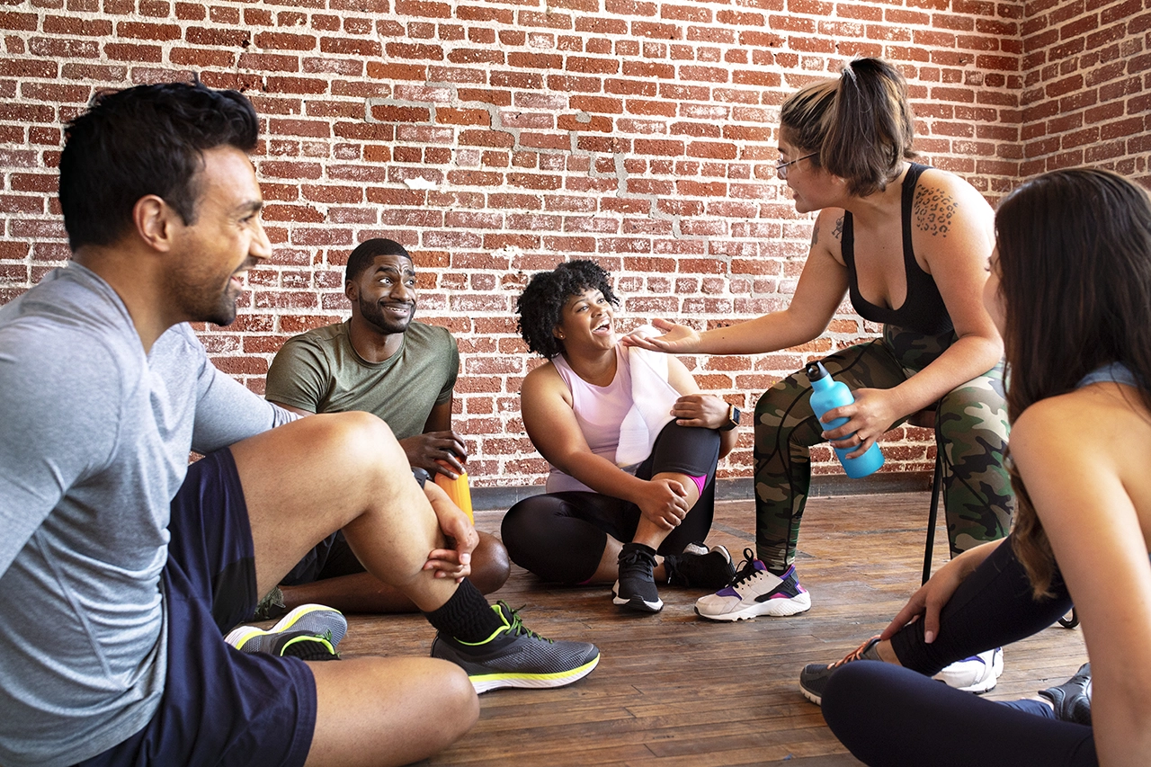 Diverse group of friends chatting after a workout class
