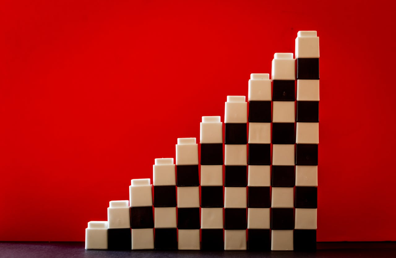 Black and white checkered blocks stacked like a ladder symbolizing growth